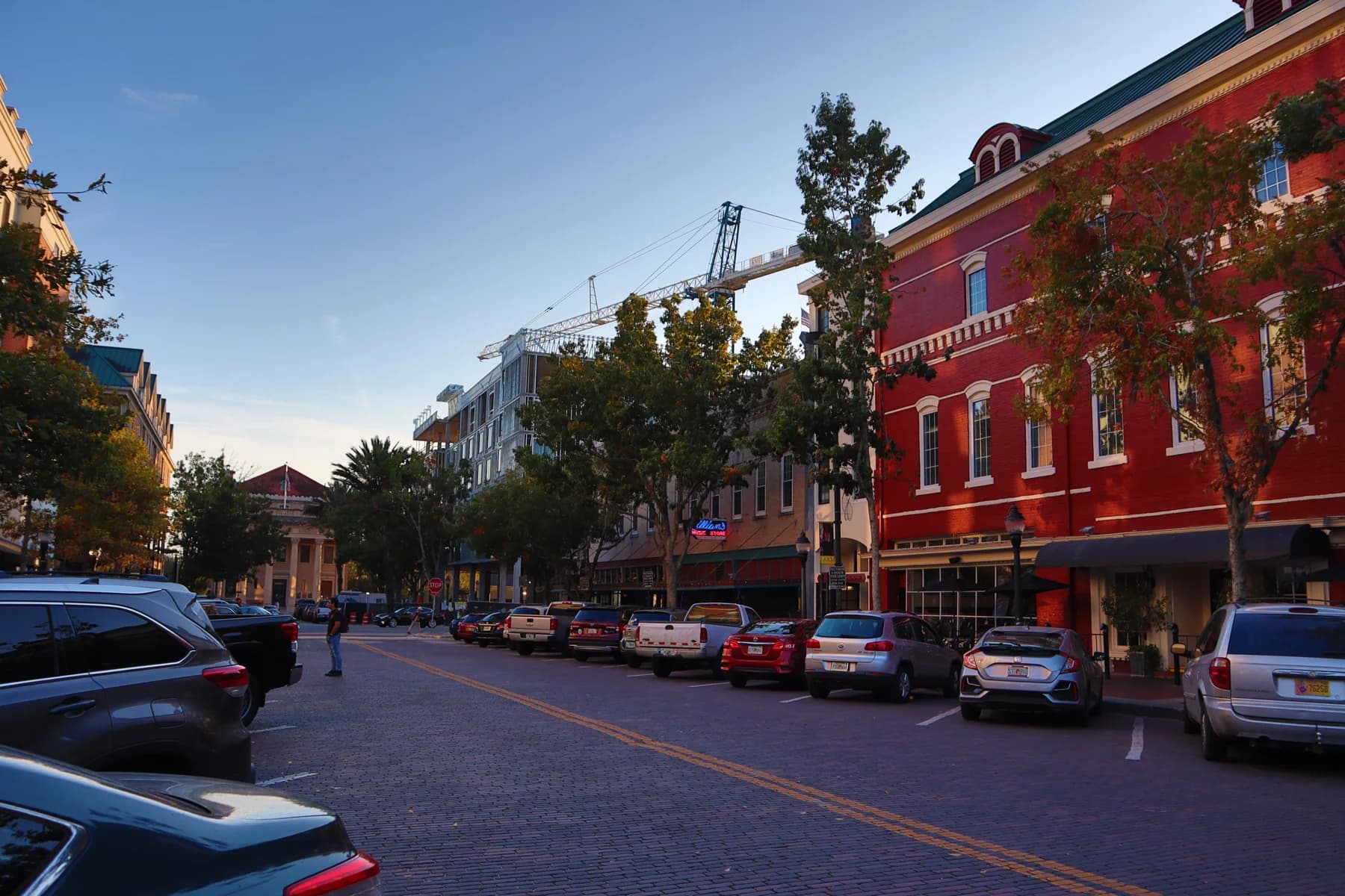 Downtown Gainesville storefronts and brick-lined streets in evening light.