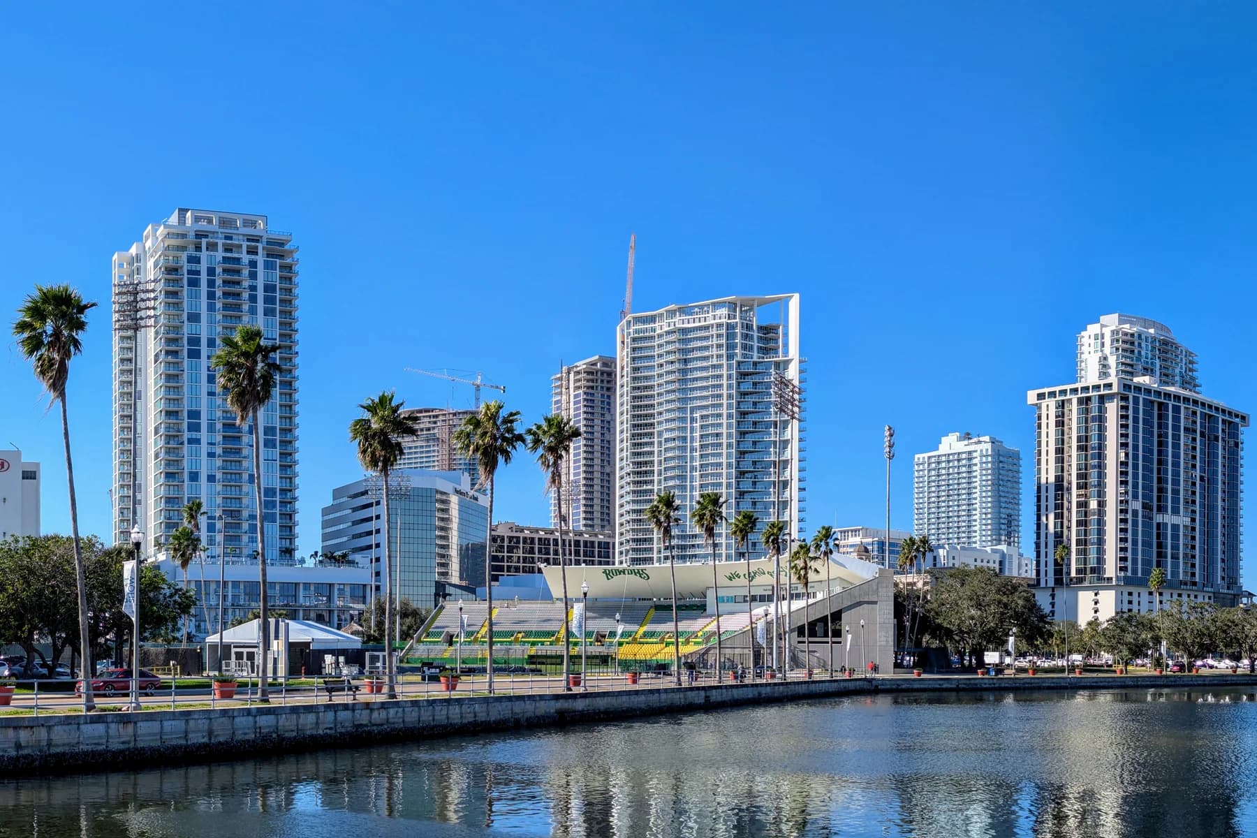 High-rise buildings and palms along the downtown St. Petersburg waterfront.