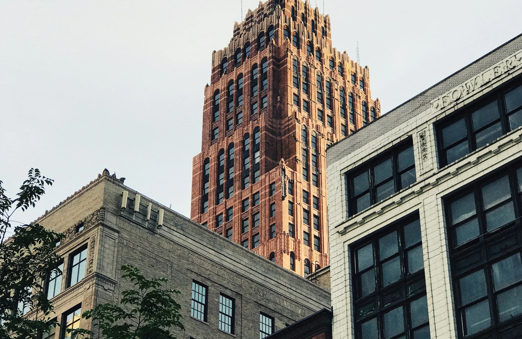 A geometric view looking up at a downtown Detroit high-rise.