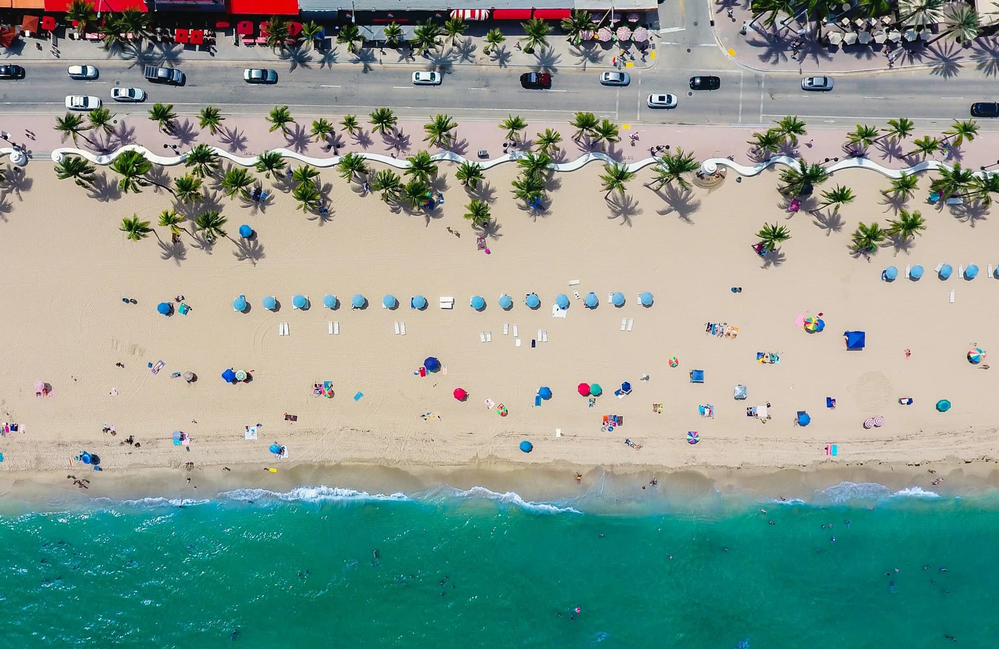 An aerial view of Fort Lauderdale Beach, the shoreline, and the coastal road.
