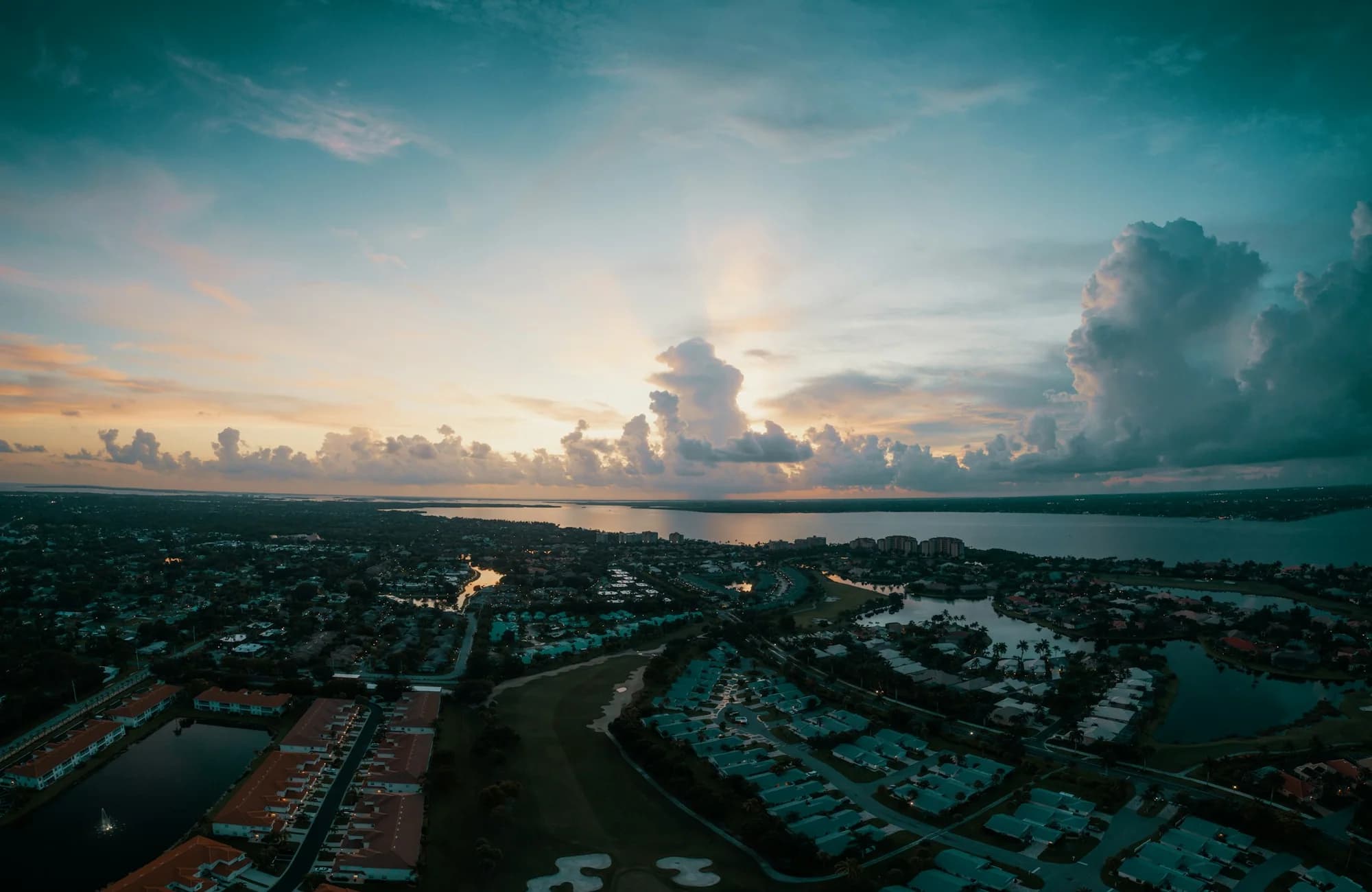 Storm clouds and evening light over Fort Myers neighborhoods and waterways.