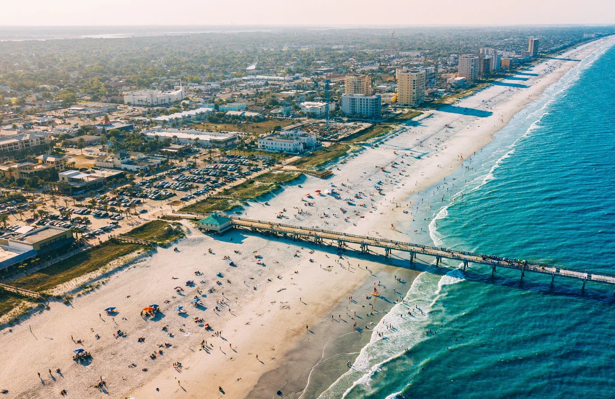 The broad shoreline at Jacksonville Beach on a clear day.