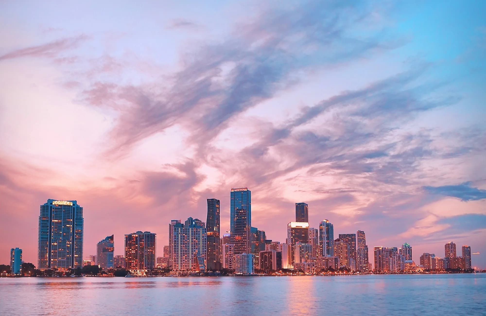 The Miami skyline rising beyond a calm waterfront.