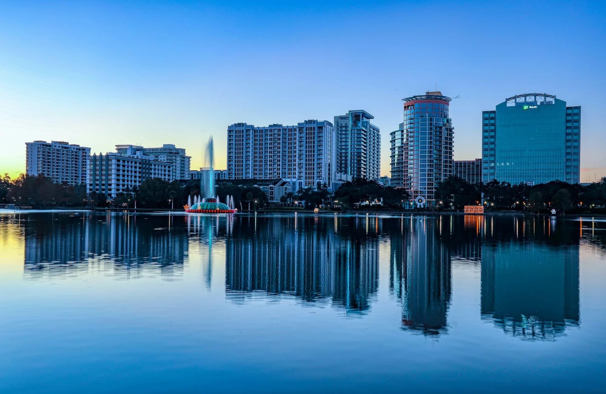 The downtown Orlando skyline reflected across Lake Eola.