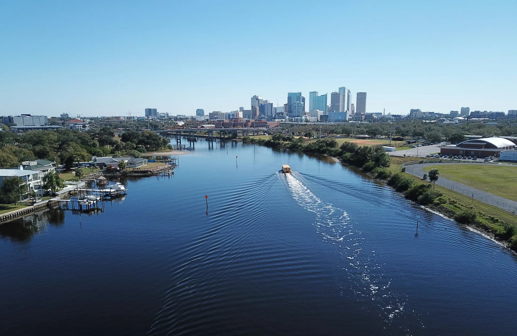 A boat crossing the water beside downtown Tampa.