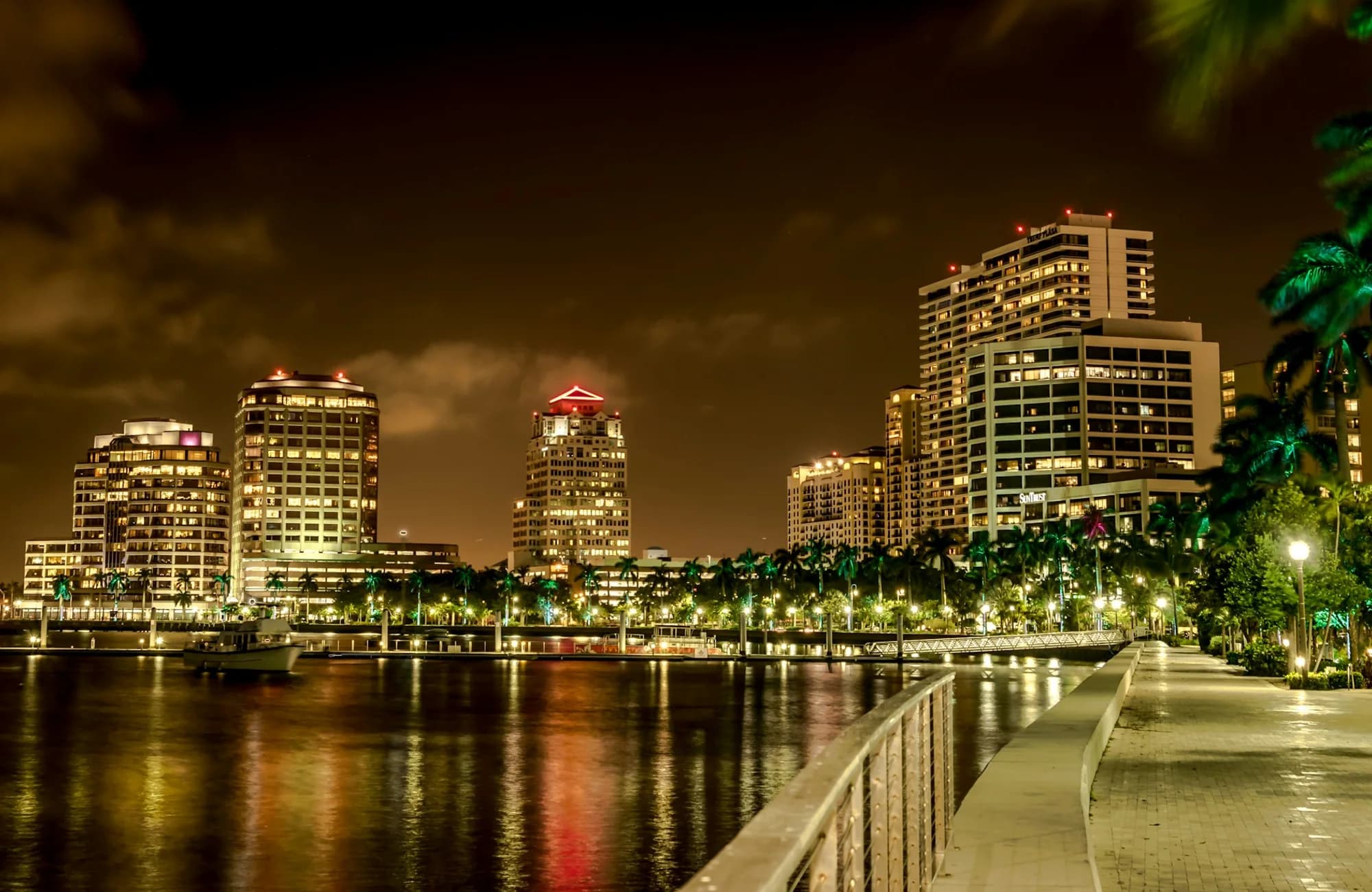 Downtown West Palm Beach illuminated beneath an evening sky.