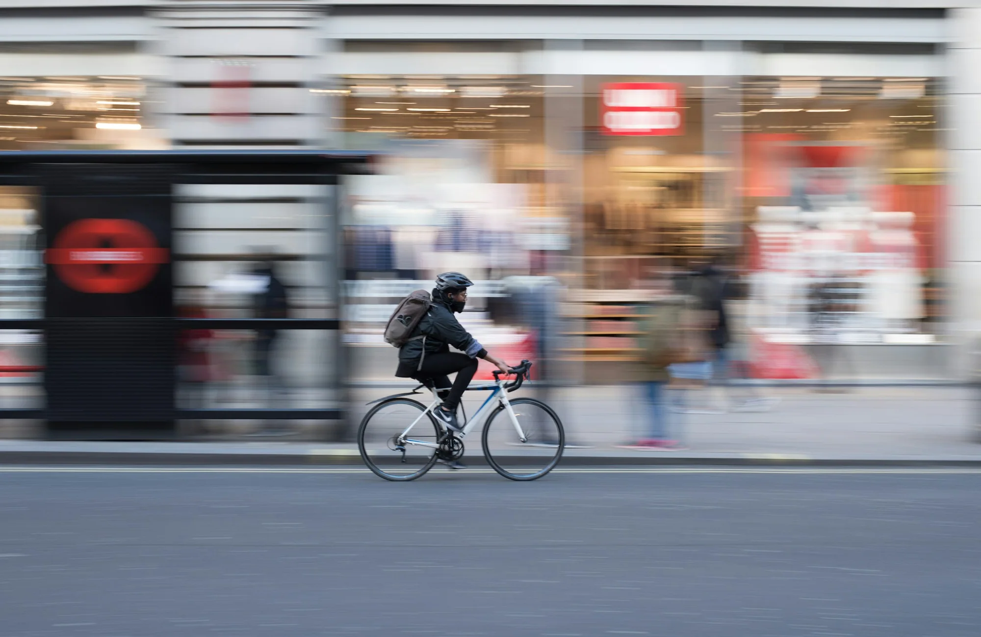 A road cyclist captured in motion on an urban street.