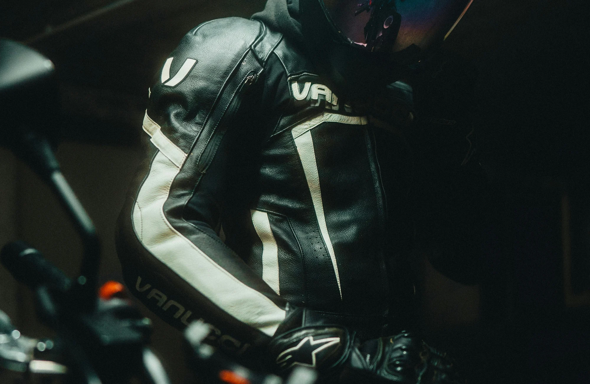 A helmeted motorcyclist in protective riding gear.